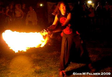 a huge ball of fire lights up this fire performer Thimbelburry festival