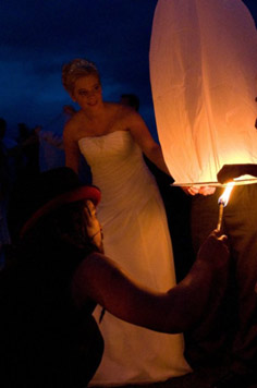 fire show at wedding sending wish lanterns off into the sky at end of performance. 